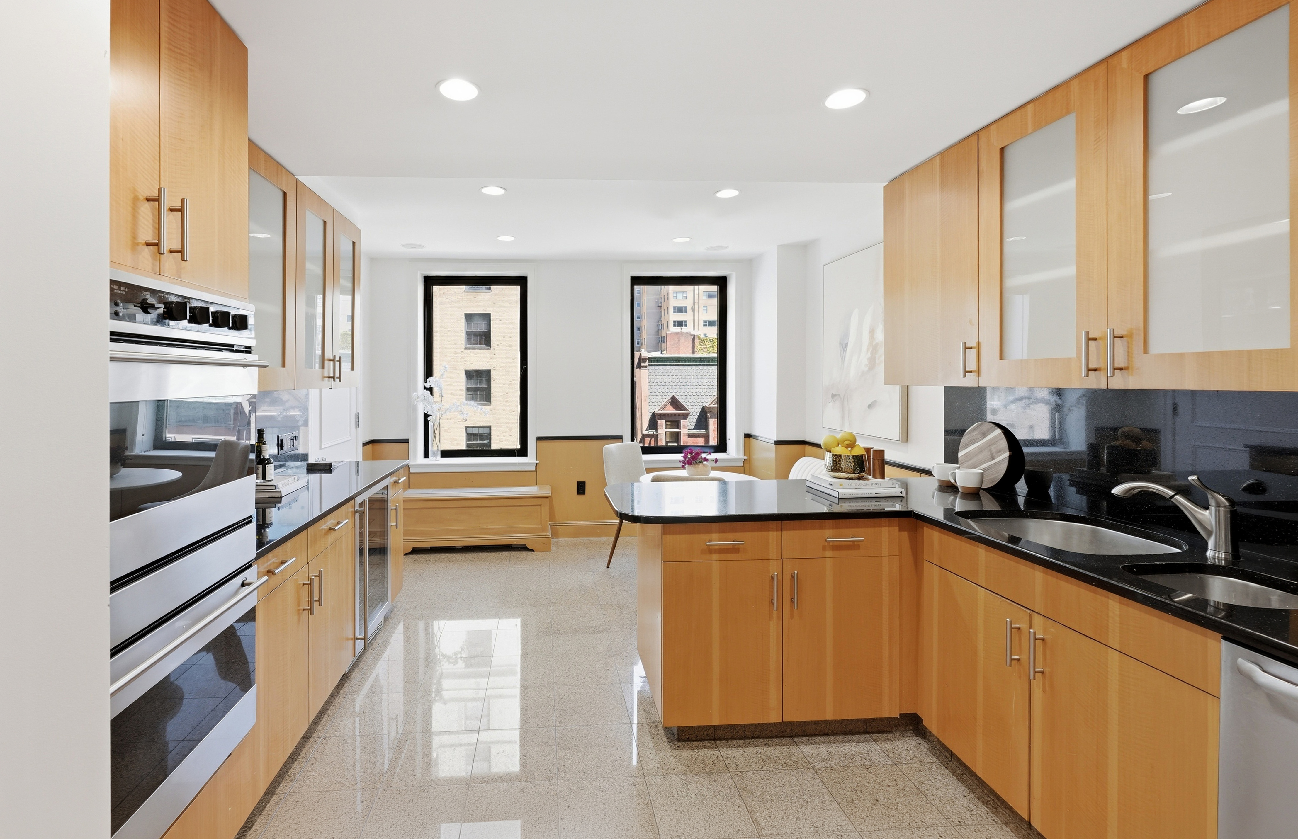 15 East 69th Street, Unit 7A Manhattan, NY 10021 - Photo 11 of 23 a large kitchen with stainless steel appliances a sink and cabinets