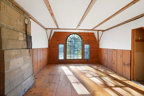 a view of hallway with stairs and wooden floor