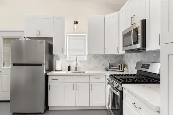 a bathroom with a toilet sink shower and a mirror