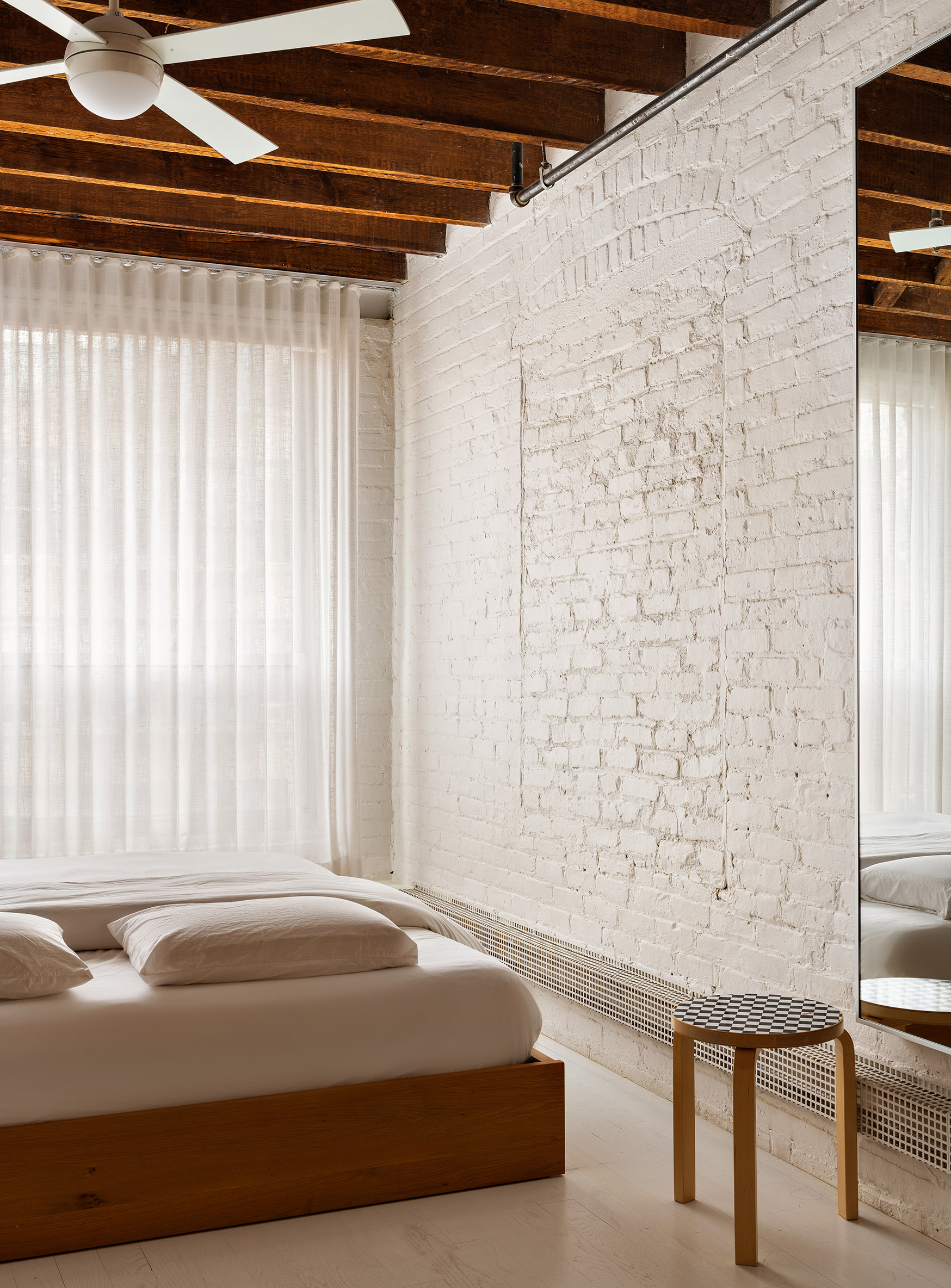 48 Canal Street, Unit 4 Manhattan, NY 10002 - Photo 8 of 13 a bedroom with a bed and a chair