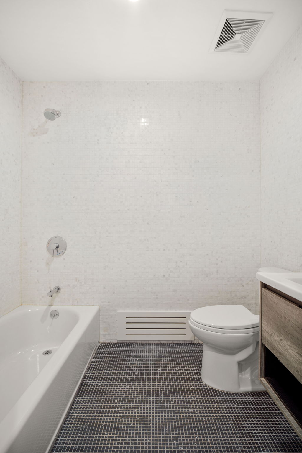 916 Greene Avenue, Unit 1 Brooklyn, NY 11221 - Photo 6 of 9 a bathroom with a toilet and a bathtub