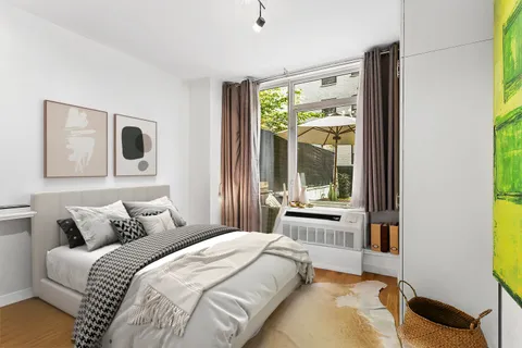 a bedroom with a bed and a large window