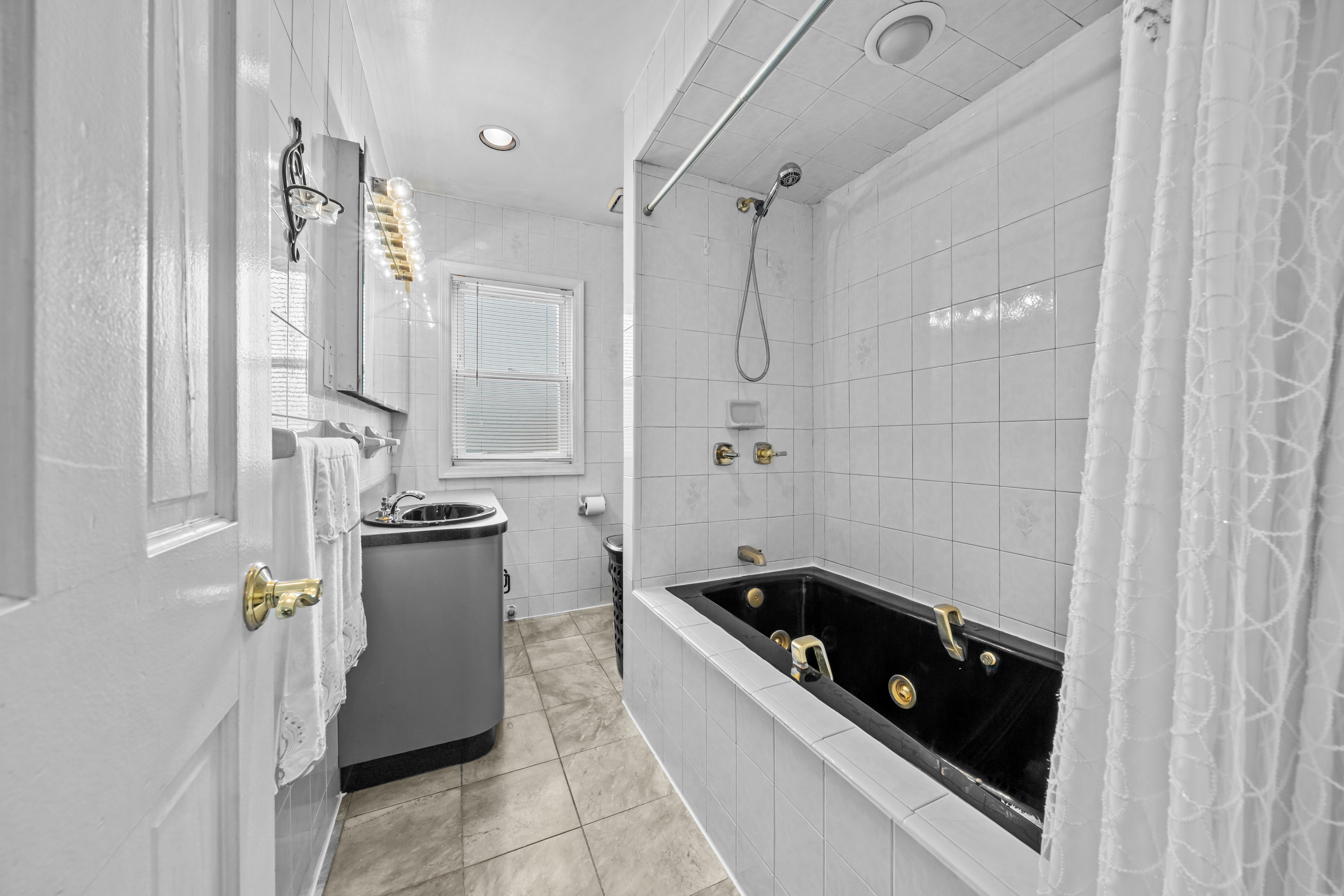 2018 Mill Avenue Brooklyn, NY 11234 - Photo 12 of 20 a bathroom with a tub sink and mirror