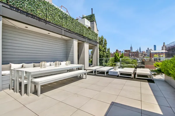 a view of a patio with couches table and chairs and potted plants