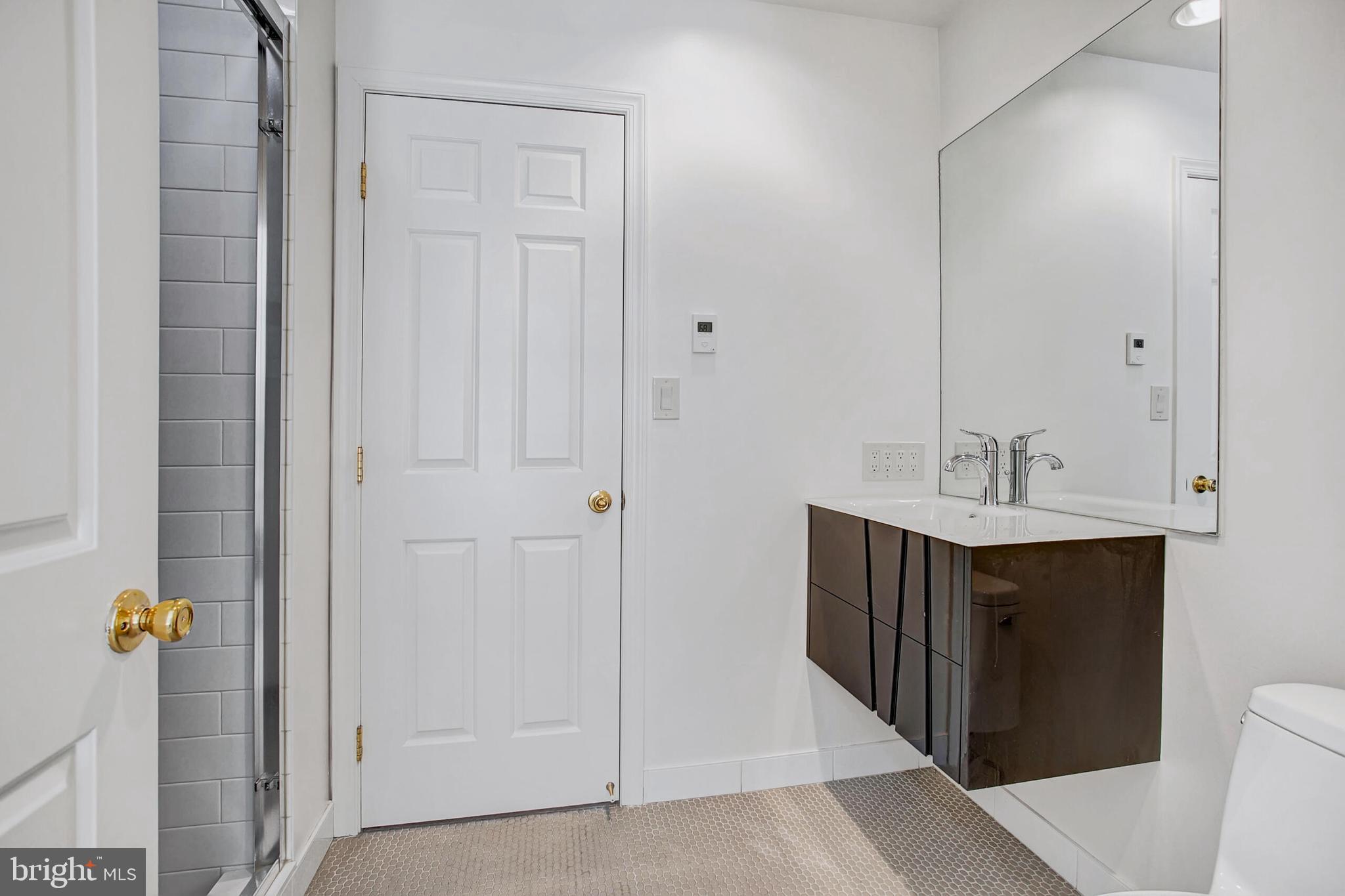 4709 Foxhall Crescent Northwest Washington, DC 20007 - Photo 40 of 57 a bathroom with a sink and a mirror