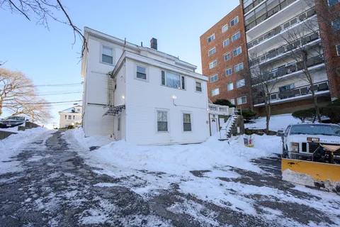 a view of a house with a backyard