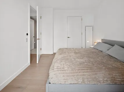 a large white bed in a white room