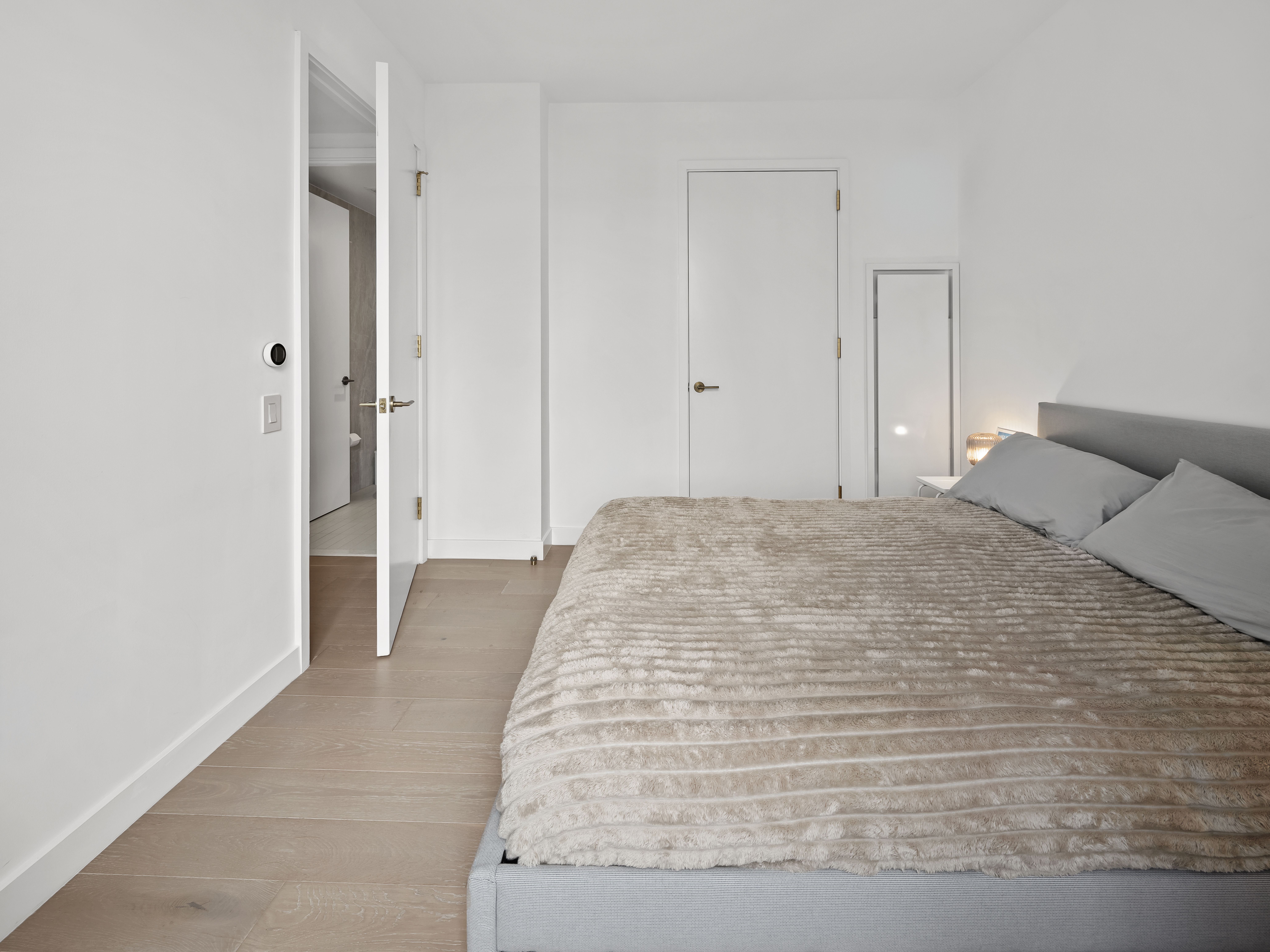 45-3 Court Square, Unit 4406 Queens, NY 11101 - Photo 8 of 22 a large white bed in a white room