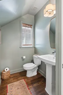 a spacious bedroom with a bed and a flat screen tv