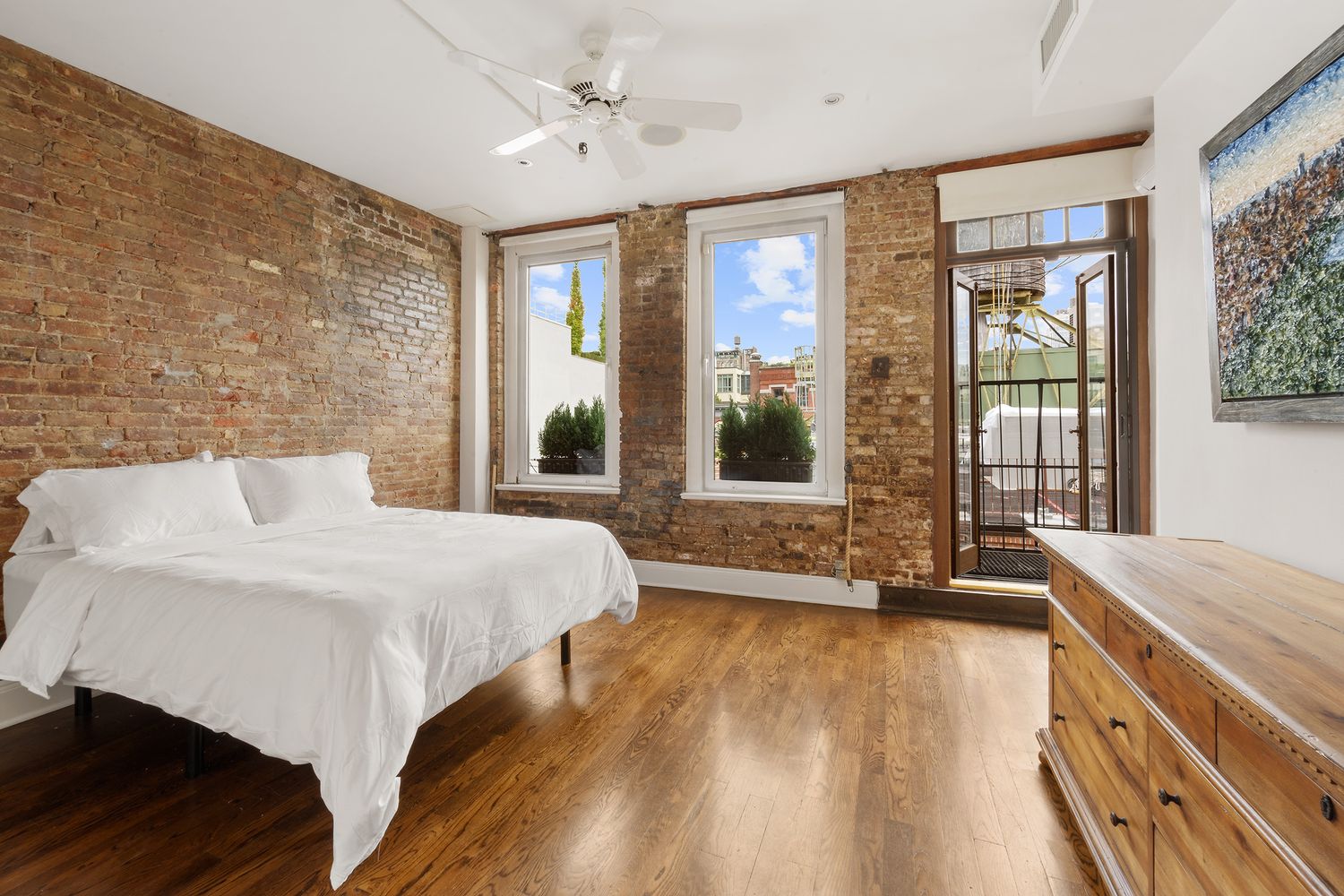 a spacious bedroom with a large bed and a large window