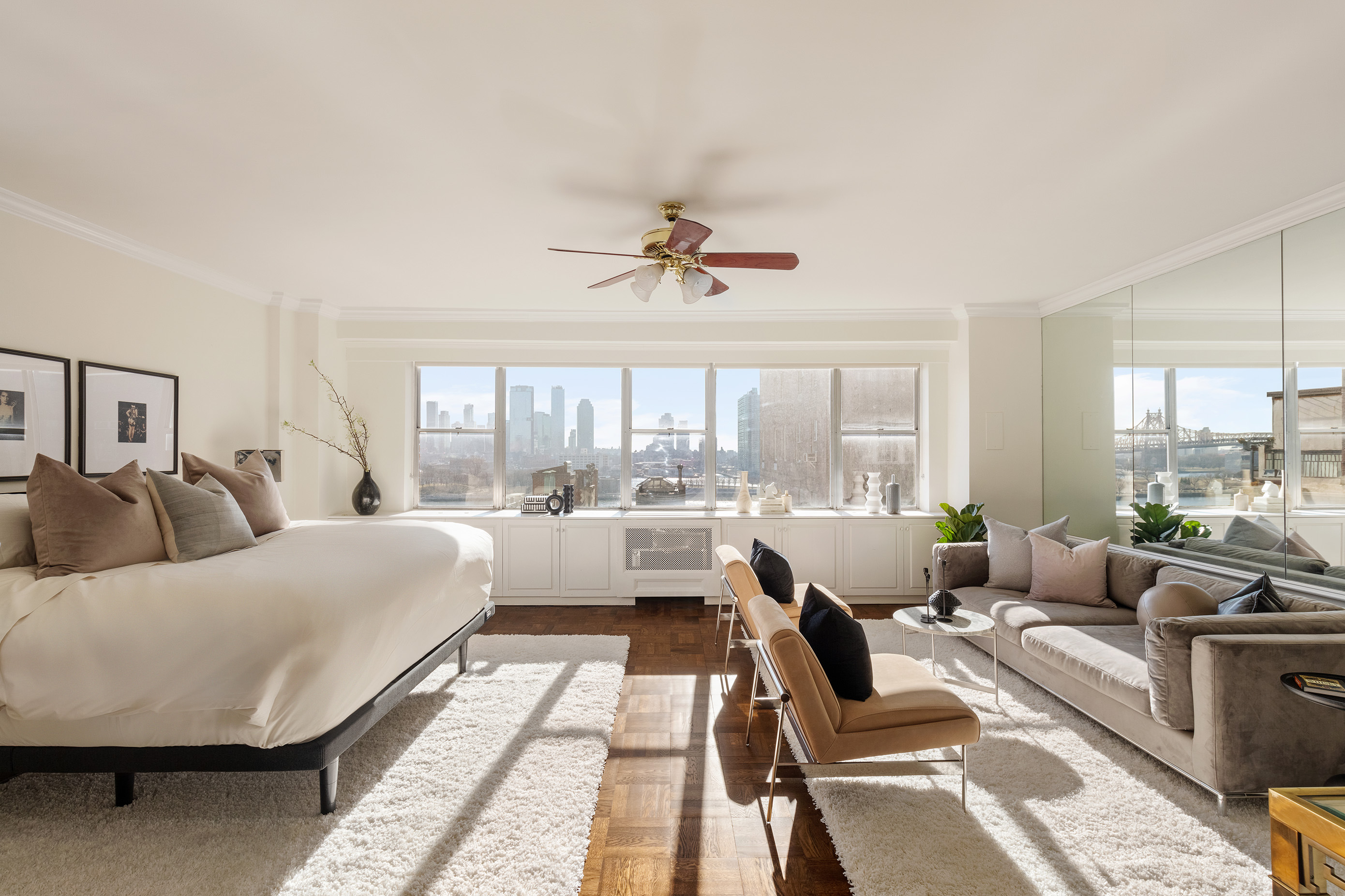12 Beekman Place, Unit 7/8B Manhattan, NY 10022 - Photo 9 of 17 a living room with furniture and a large window