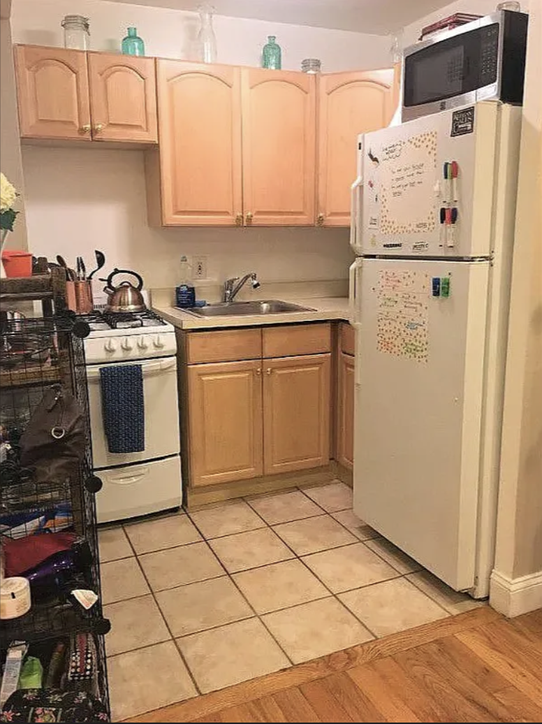 305 East 95th Street, Unit 4E Manhattan, NY 10128 - Photo 4 of 12 a kitchen with a refrigerator sink and cabinets