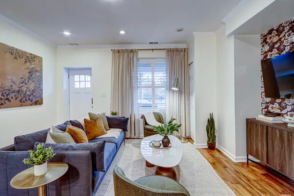 a living room with furniture kitchen and a window