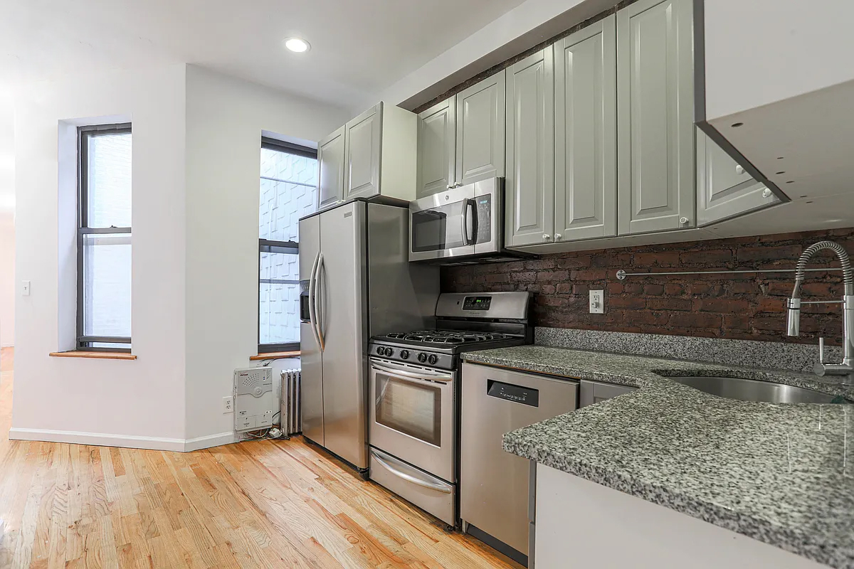 199 Java Street Brooklyn, NY 11222 - Photo 13 of 32 a kitchen with a refrigerator sink and cabinets