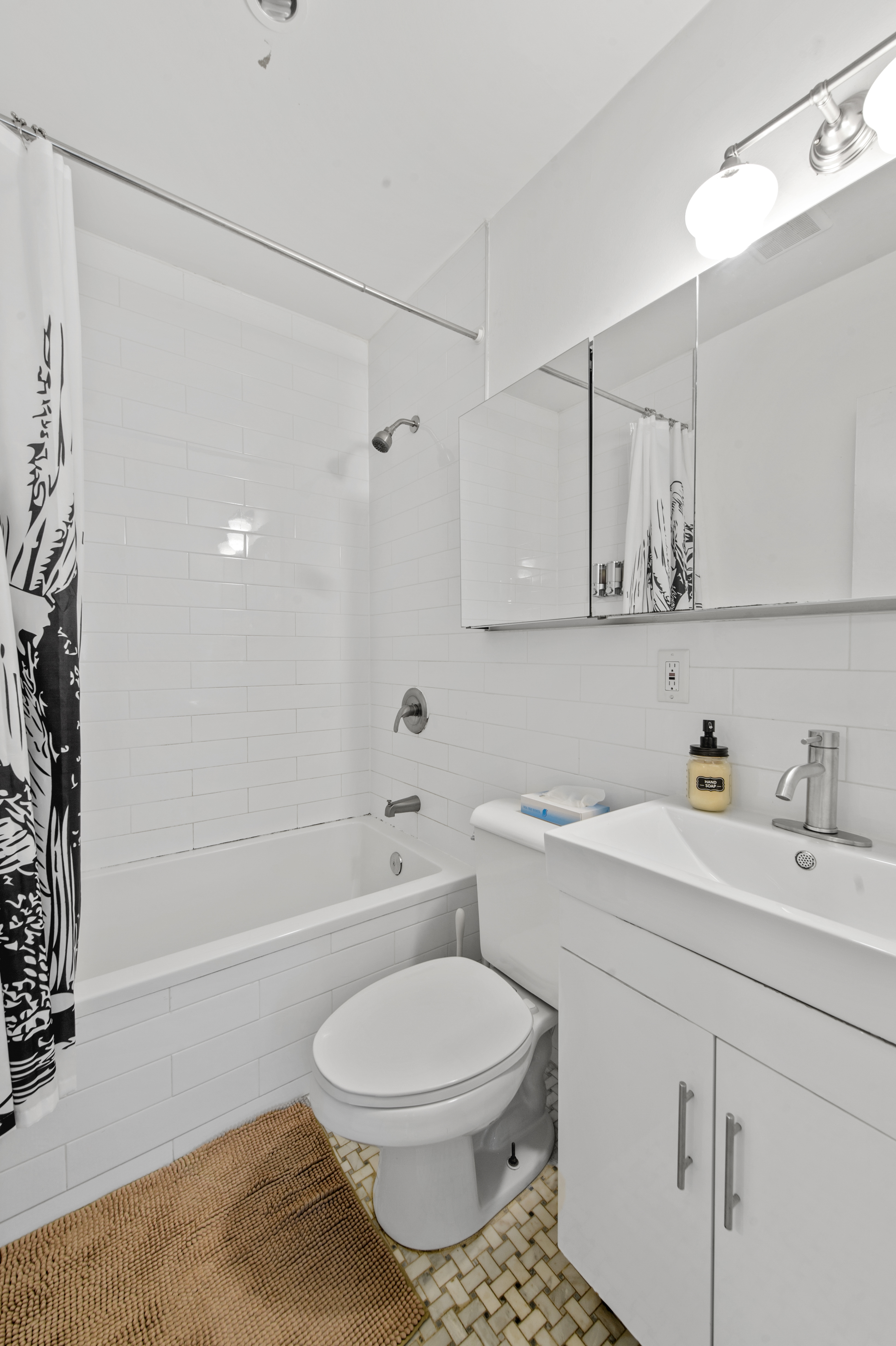 185 A Powers Street, Unit 1 Brooklyn, NY 11211 - Photo 5 of 13 a bathroom with a sink a toilet and vanity