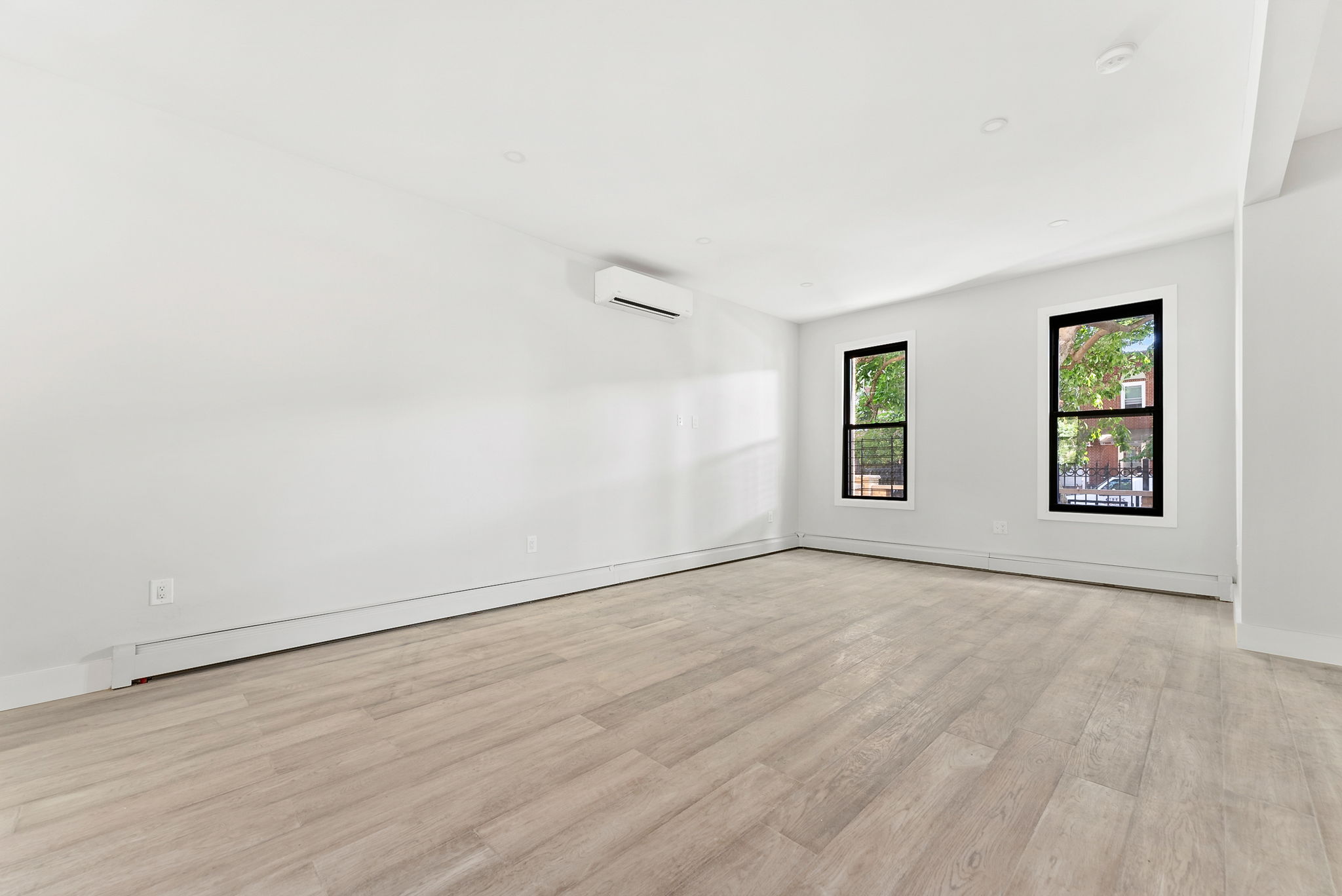 1414 30th Road Queens, NY 11102 - Photo 4 of 16 an empty room with windows