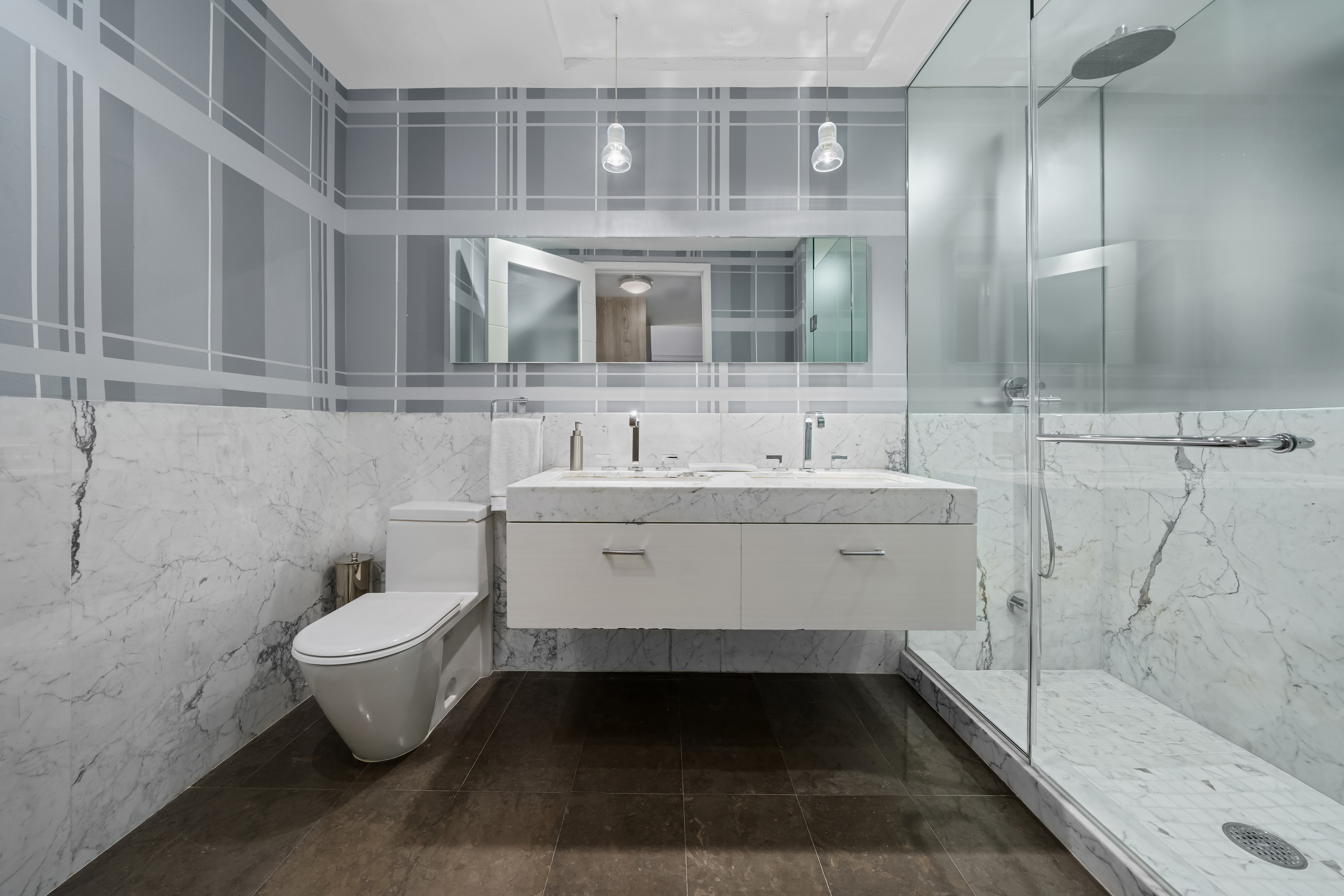 92 Greene Street, Unit 3B Manhattan, NY 10012 - Photo 5 of 8 a bathroom with a sink toilet and shower