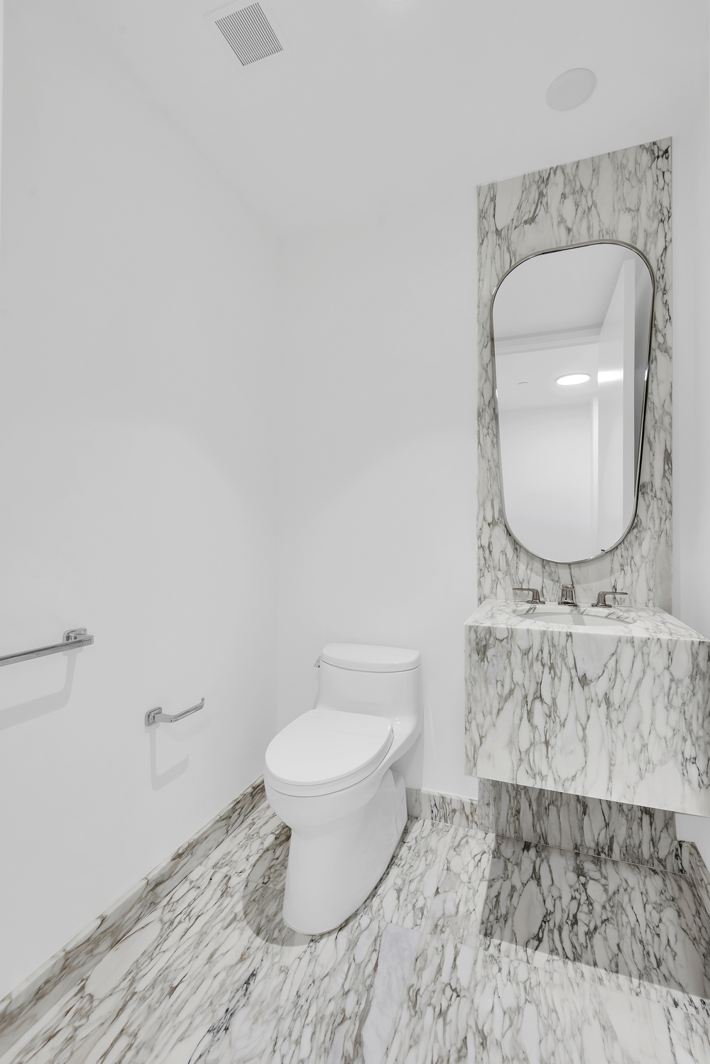 50 West 66th Street, Unit 7B Manhattan, NY 10023 - Photo 8 of 24 a bathroom with a toilet a sink and a mirror