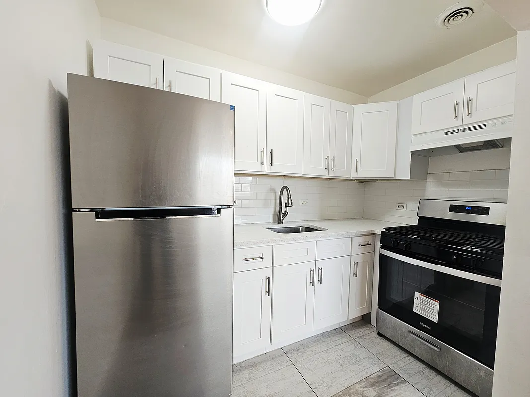 a kitchen with stainless steel appliances granite countertop a refrigerator a stove a sink and cabinets