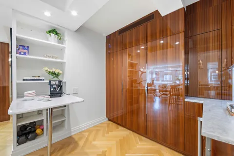 a kitchen with stainless steel appliances a dining table chairs and chandelier
