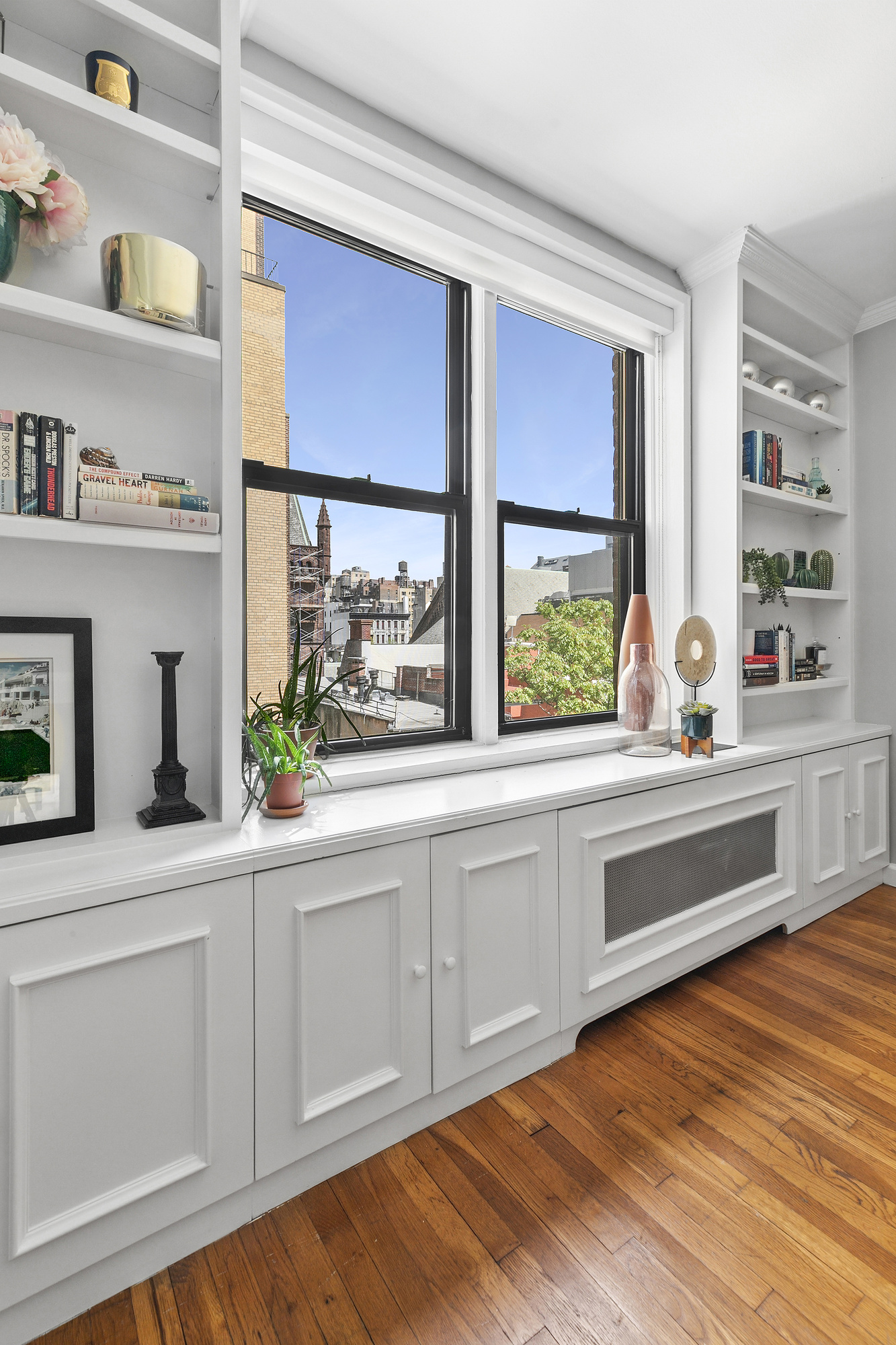 201 East 15th Street, Unit 7AJ Manhattan, NY 10003 - Photo 2 of 10 a kitchen with stainless steel appliances white cabinets and a large window