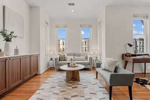 a view of a dining room with furniture and wooden floor