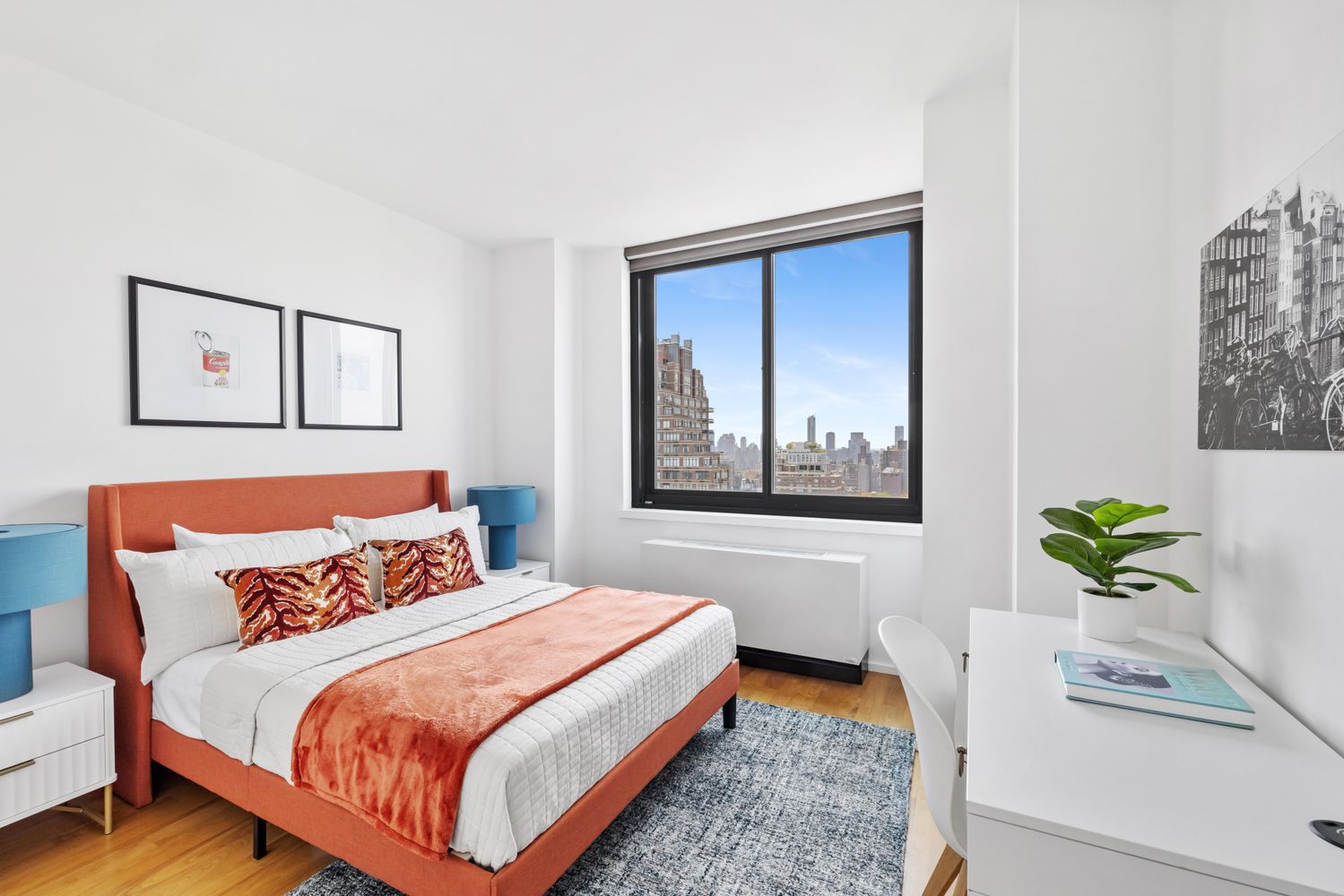 a bedroom with a bed and painting on the wall