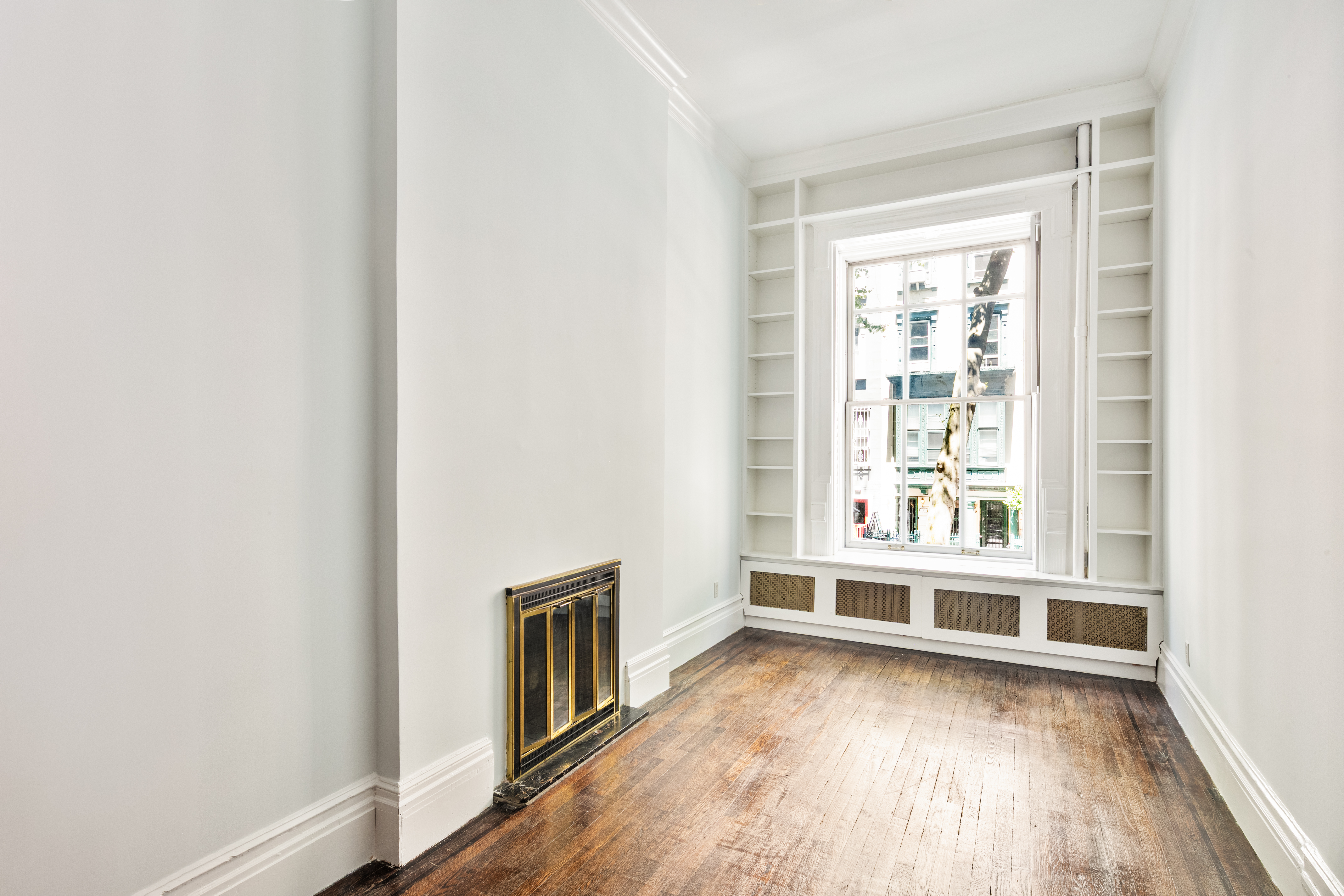 112 West 78th Street, Unit PARLOR Manhattan, NY 10024 - Photo 8 of 37 an empty room with wooden floor and windows