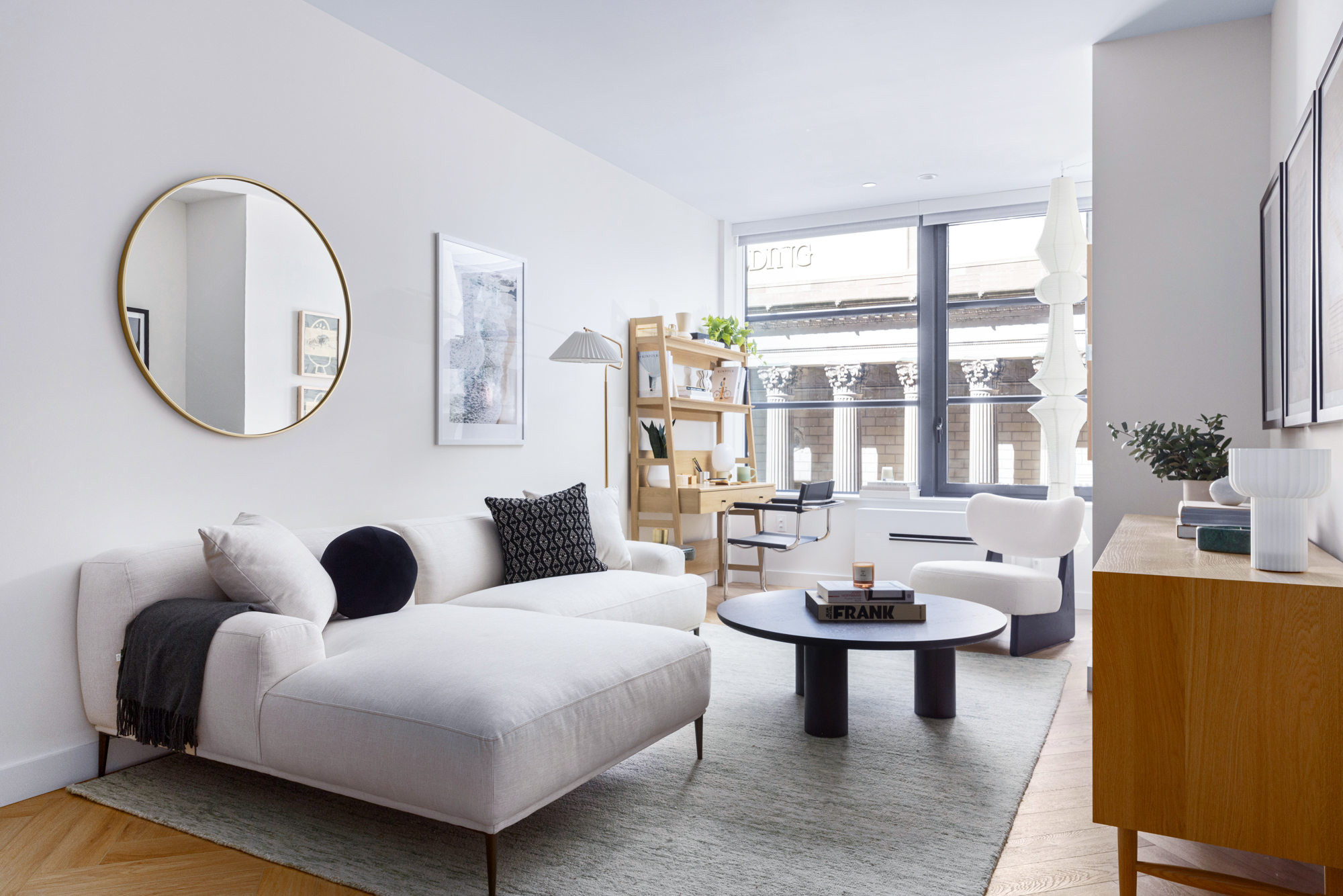980 6th Avenue, Unit 412 Manhattan, NY 10018 - Photo 2 of 21 a living room with furniture a table and a large window