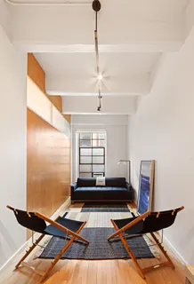 a room with gym equipment and wooden floor