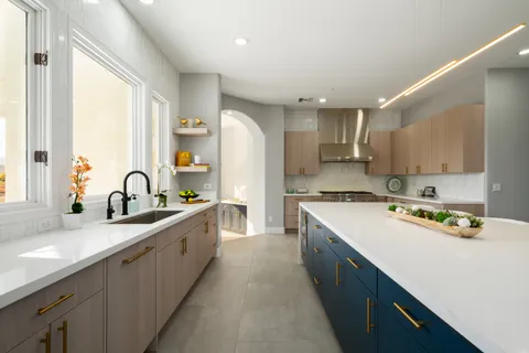 a large kitchen with a large counter top appliances and cabinets