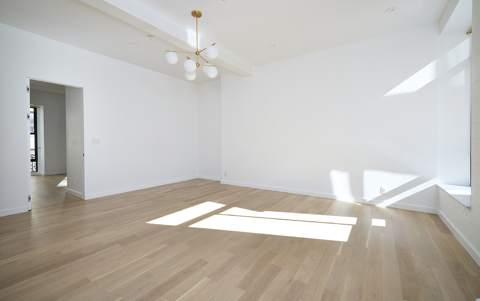 23 East 10th Street, Unit 508 Manhattan, NY 10003 - Photo 11 of 21 a view of a big room with wooden floor and windows