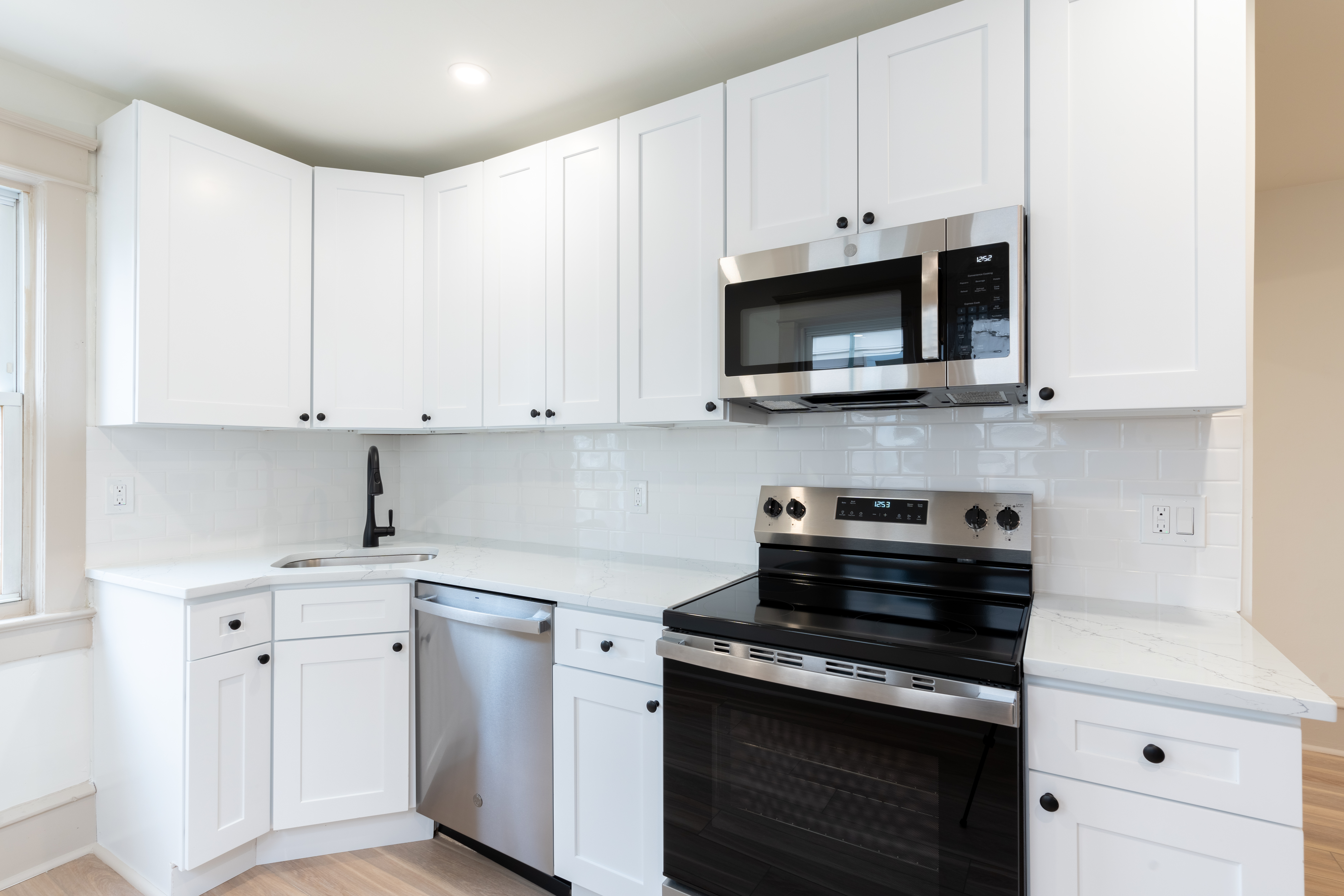 423 North Haddon Avenue Haddonfield, NJ 08033 - Photo 3 of 16 a kitchen with stainless steel appliances granite countertop grey cabinets a stove a sink and dishwasher