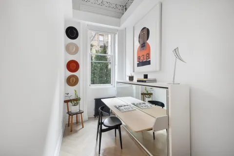 a balcony with a table and chairs in it