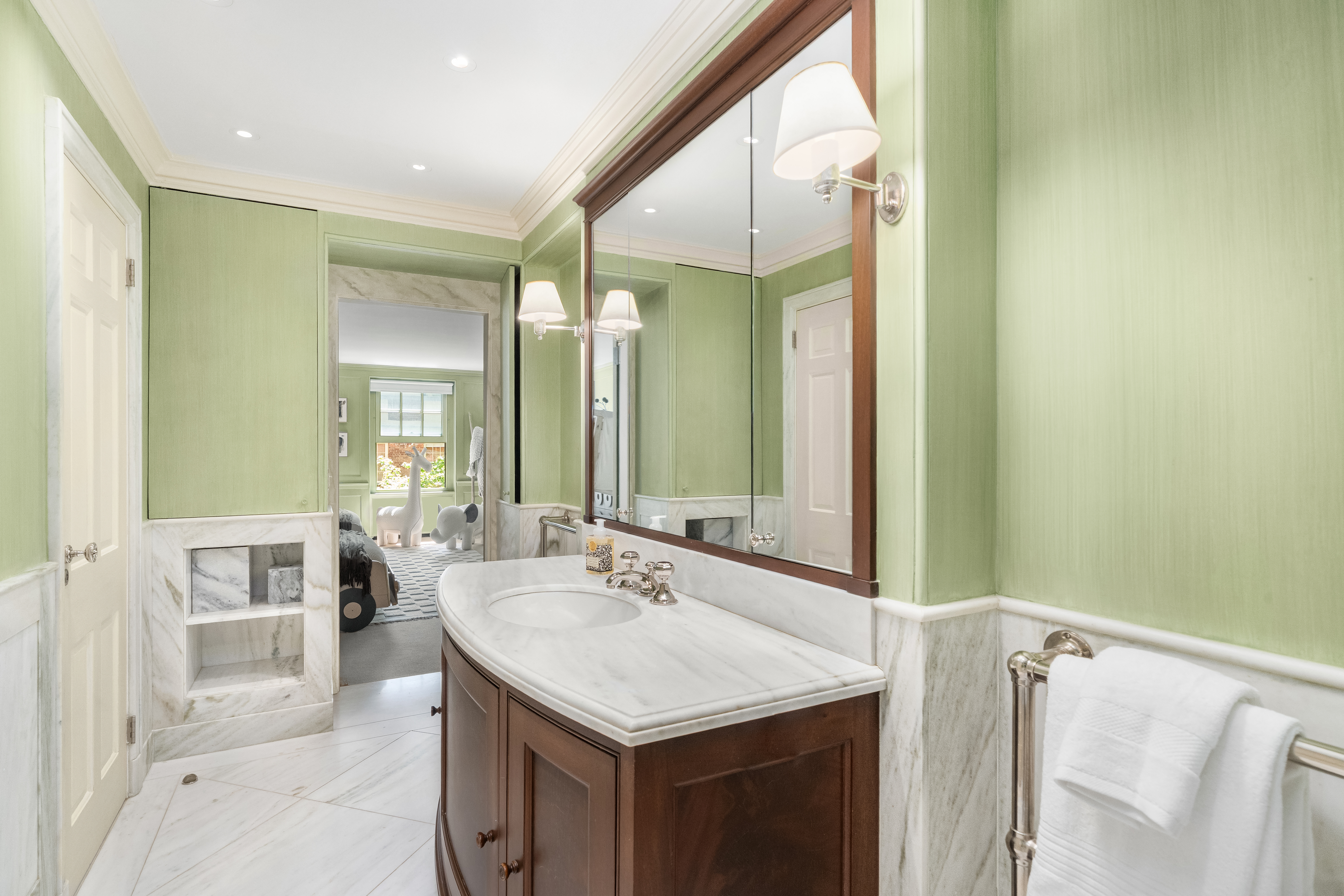 46 East 71st Street Manhattan, NY 10021 - Photo 20 of 27 a bathroom with a sink and a mirror