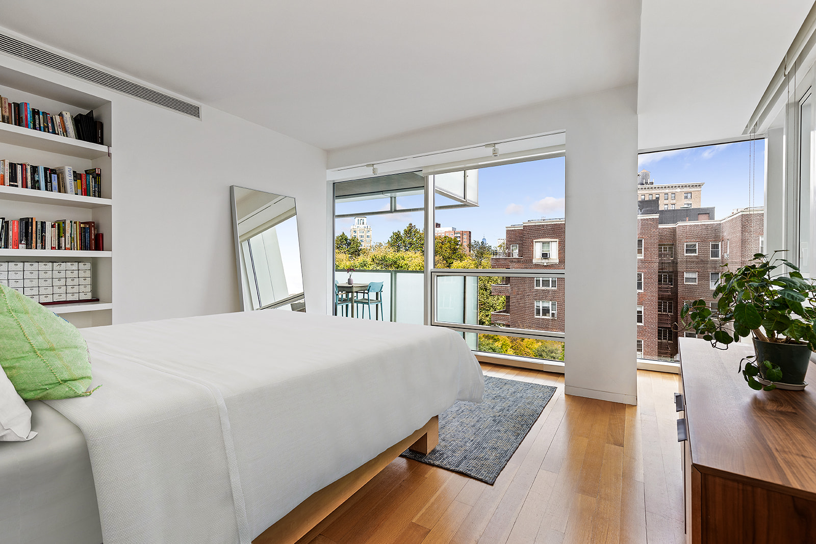 1 Grand Army Plaza, Unit 5C Brooklyn, NY 11238 - Photo 7 of 17 a bedroom with a large bed and a large window