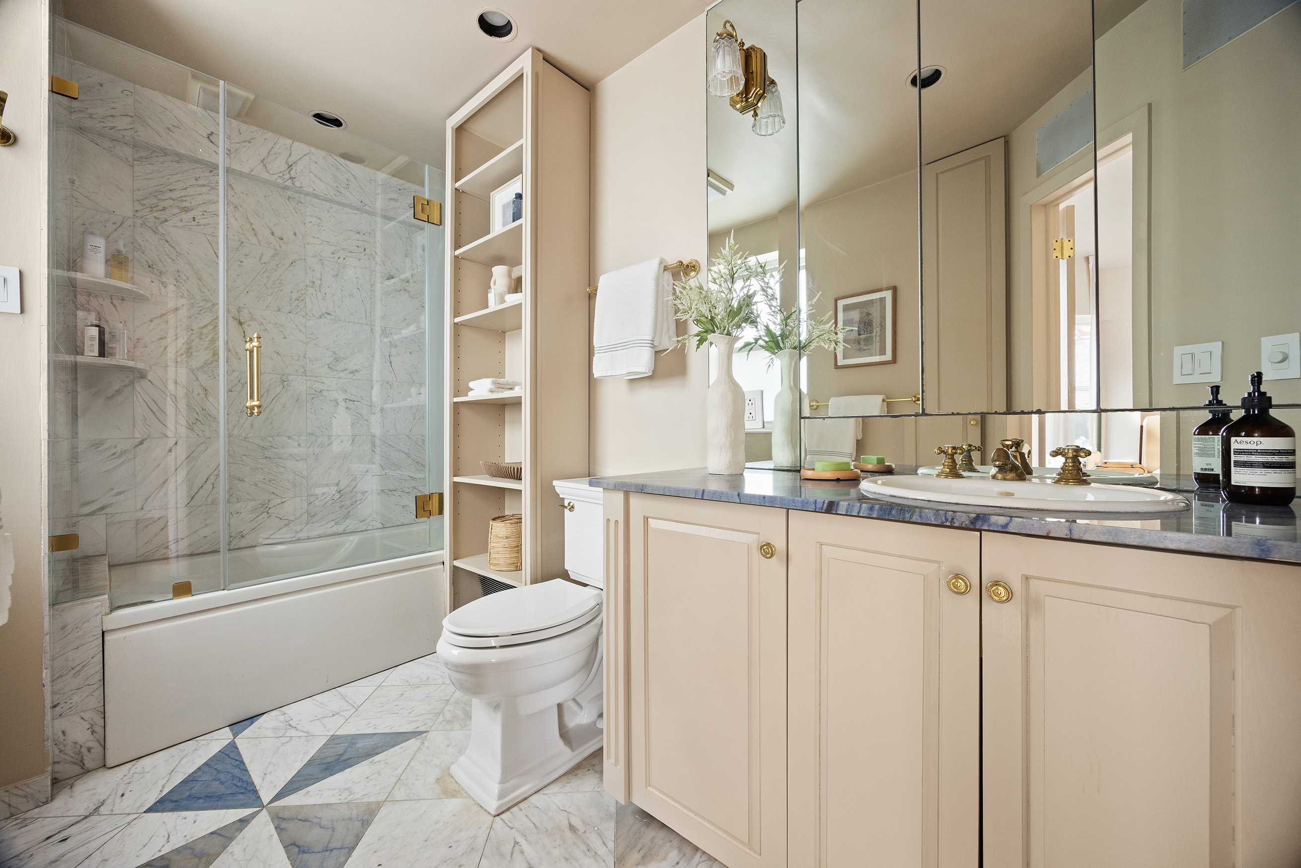 40 East 84th Street, Unit 17A Manhattan, NY 10028 - Photo 9 of 16 a bathroom with a granite countertop sink a toilet and shower