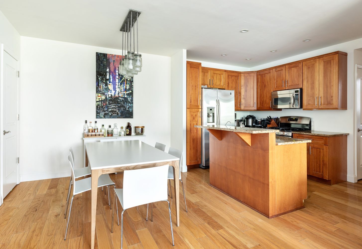52 Dean Street, Unit 4A Brooklyn, NY 11201 - Photo 2 of 7 a kitchen with kitchen island a stove a sink a dining table and chairs