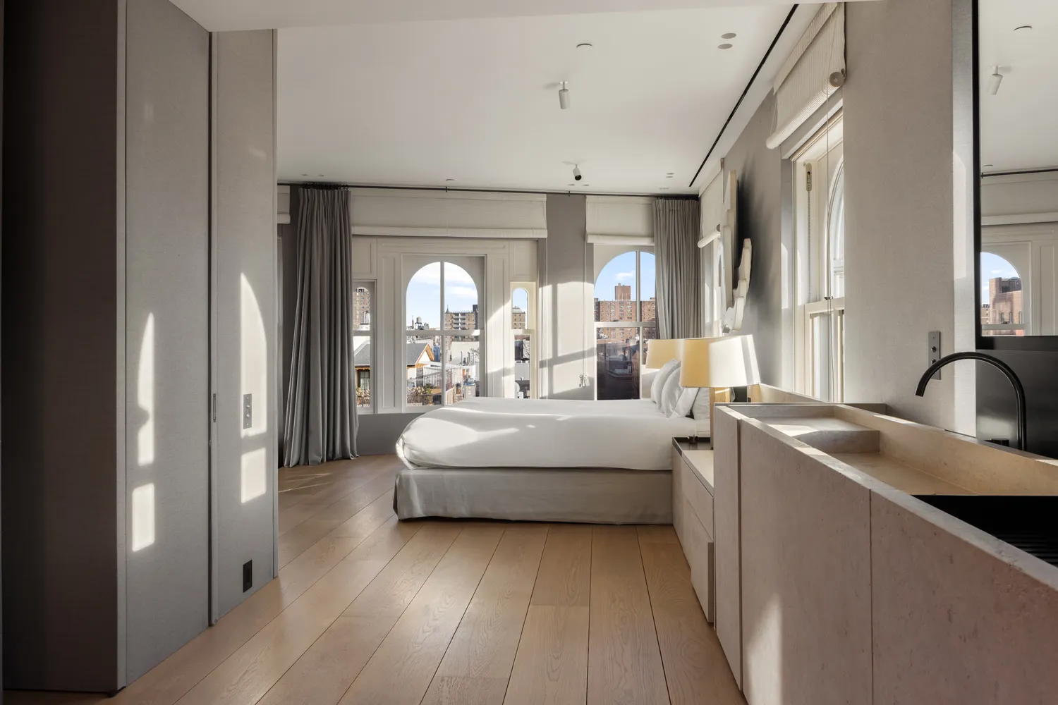 a living room with stainless steel appliances furniture and a large window