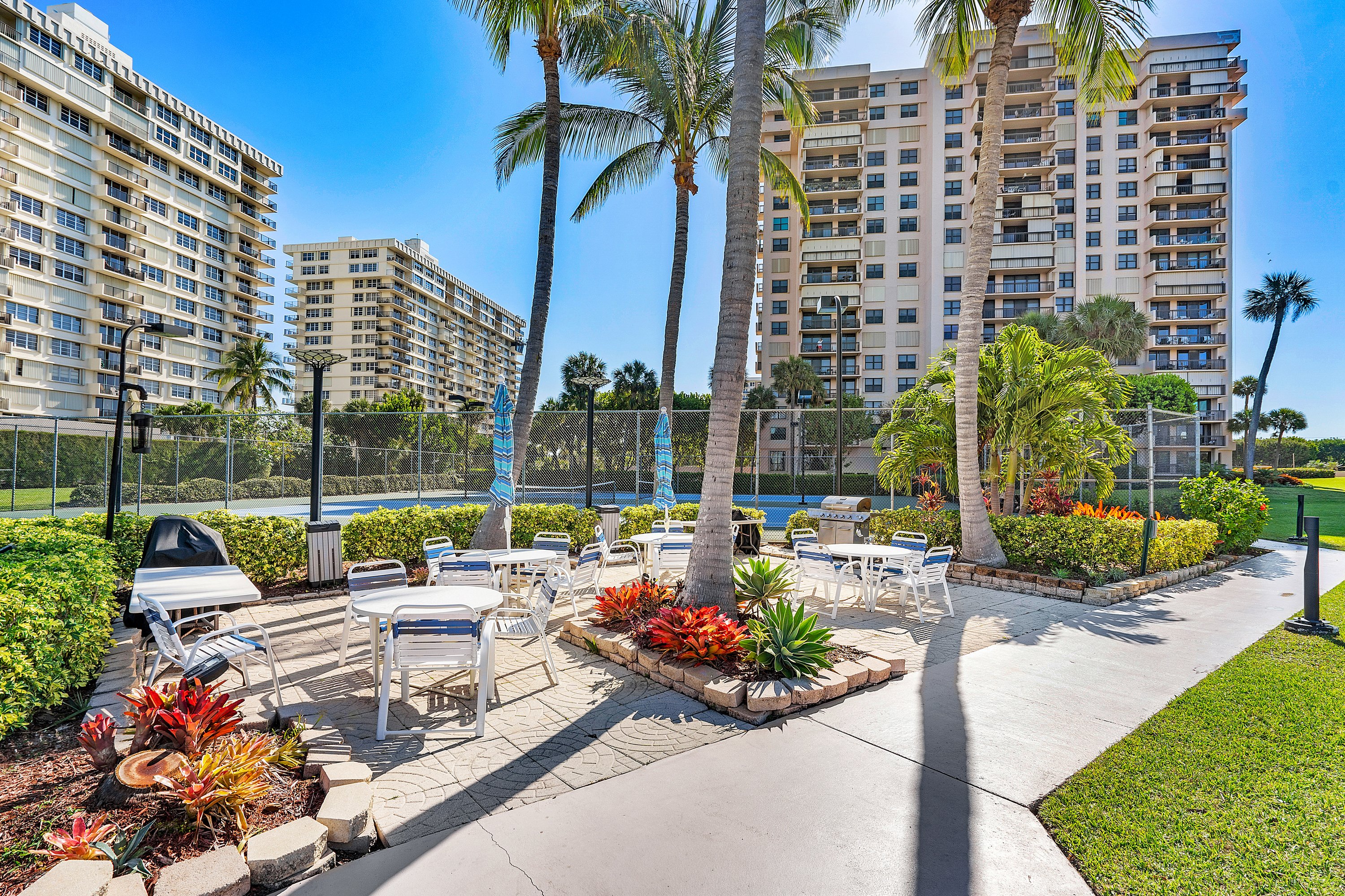 2003 North Ocean Boulevard, Unit 305 Boca Raton, FL 33431 - Photo 52 of 56 a view of a patio with couches and table and chairs and potted plants