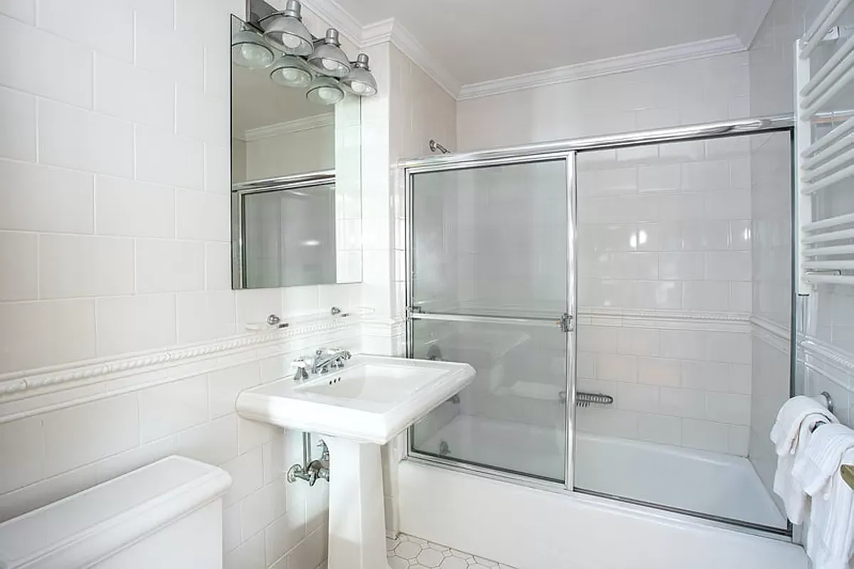 404 East 76th Street, Unit 30C Manhattan, NY 10021 - Photo 17 of 24 a bathroom with a sink toilet and shower