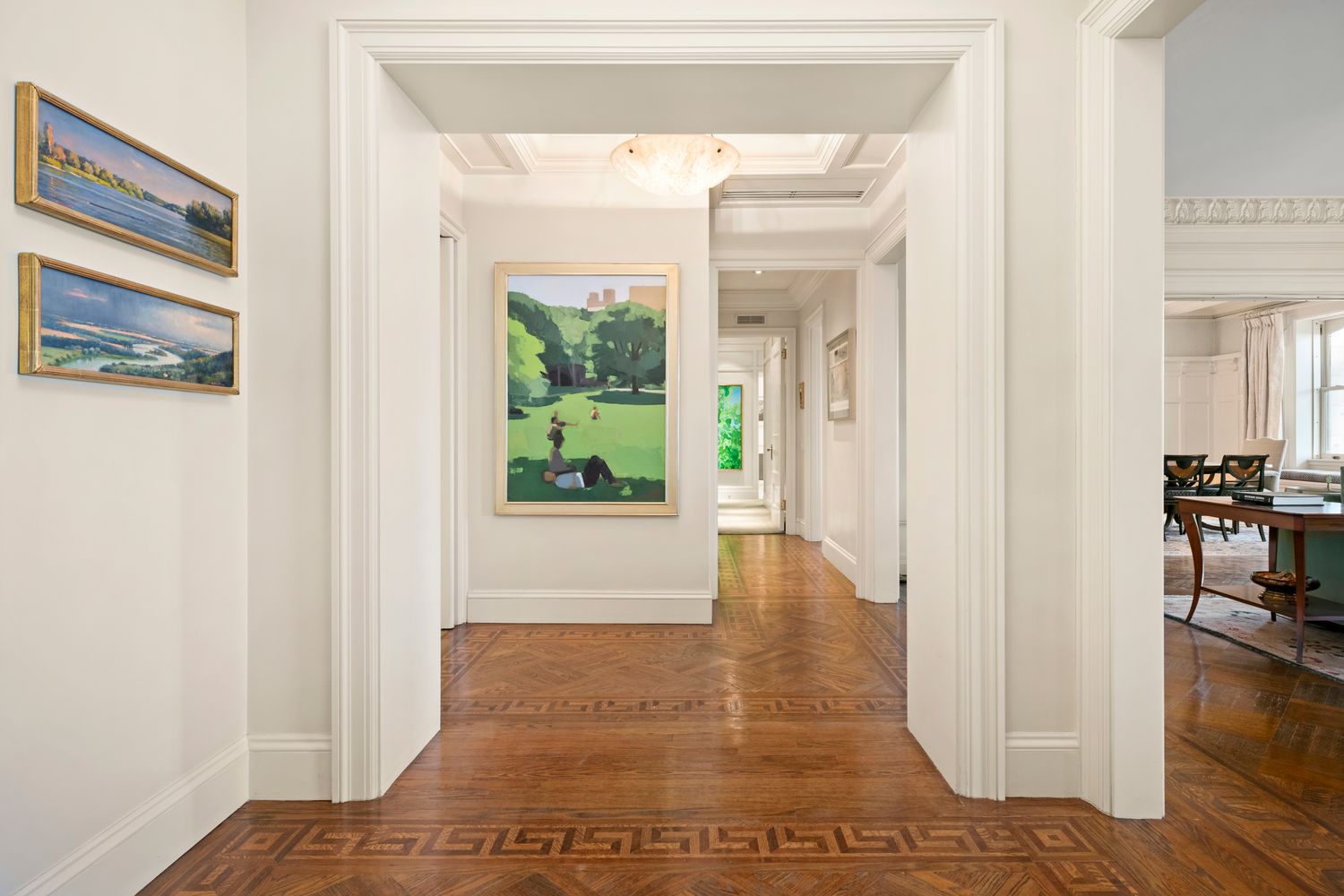 a view of a hallway with wooden floor and dining room