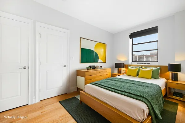 a bedroom with a bed and large windows