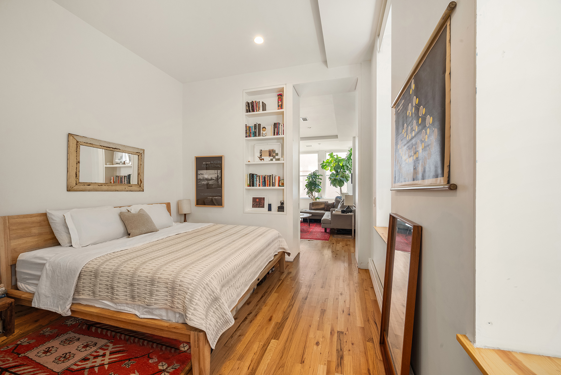 175 East Broadway, Unit 4C Manhattan, NY 10002 - Photo 6 of 14 a bedroom with a bed next to a window with the outer view