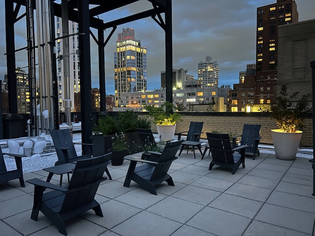 136 East 36th Street, Unit 9/10C Manhattan, NY 10016 - Photo 20 of 27 a living room with patio furniture and a floor to ceiling window