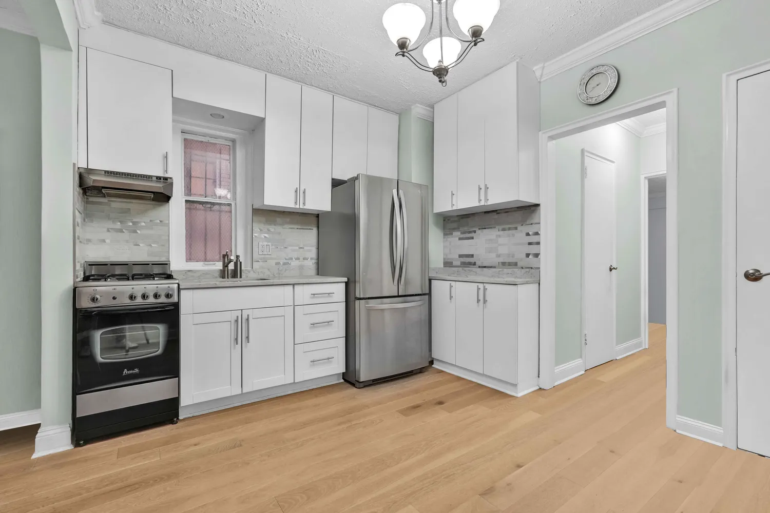 a kitchen with a refrigerator stove and wooden cabinets