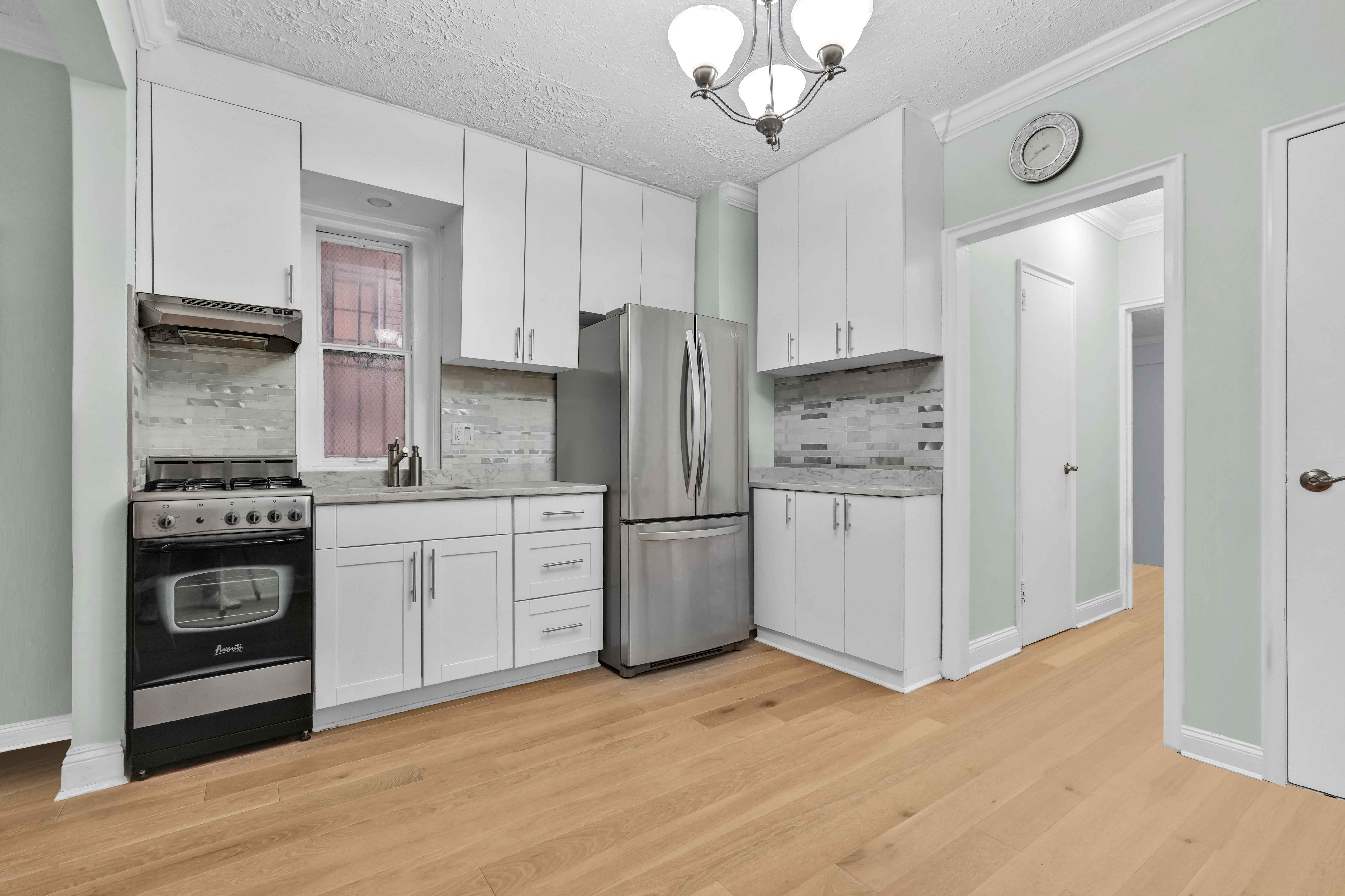 57 Montague Street, Unit 1D Brooklyn, NY 11201 - Photo 6 of 27 a kitchen with a refrigerator stove and wooden cabinets