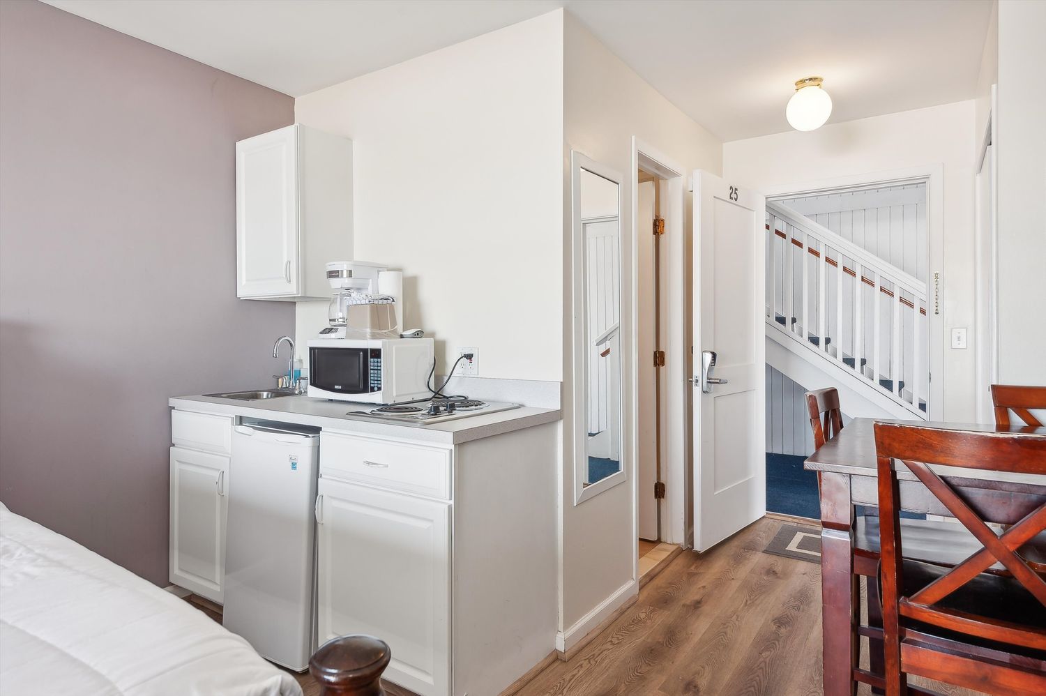 a bathroom with a sink a toilet and mirror