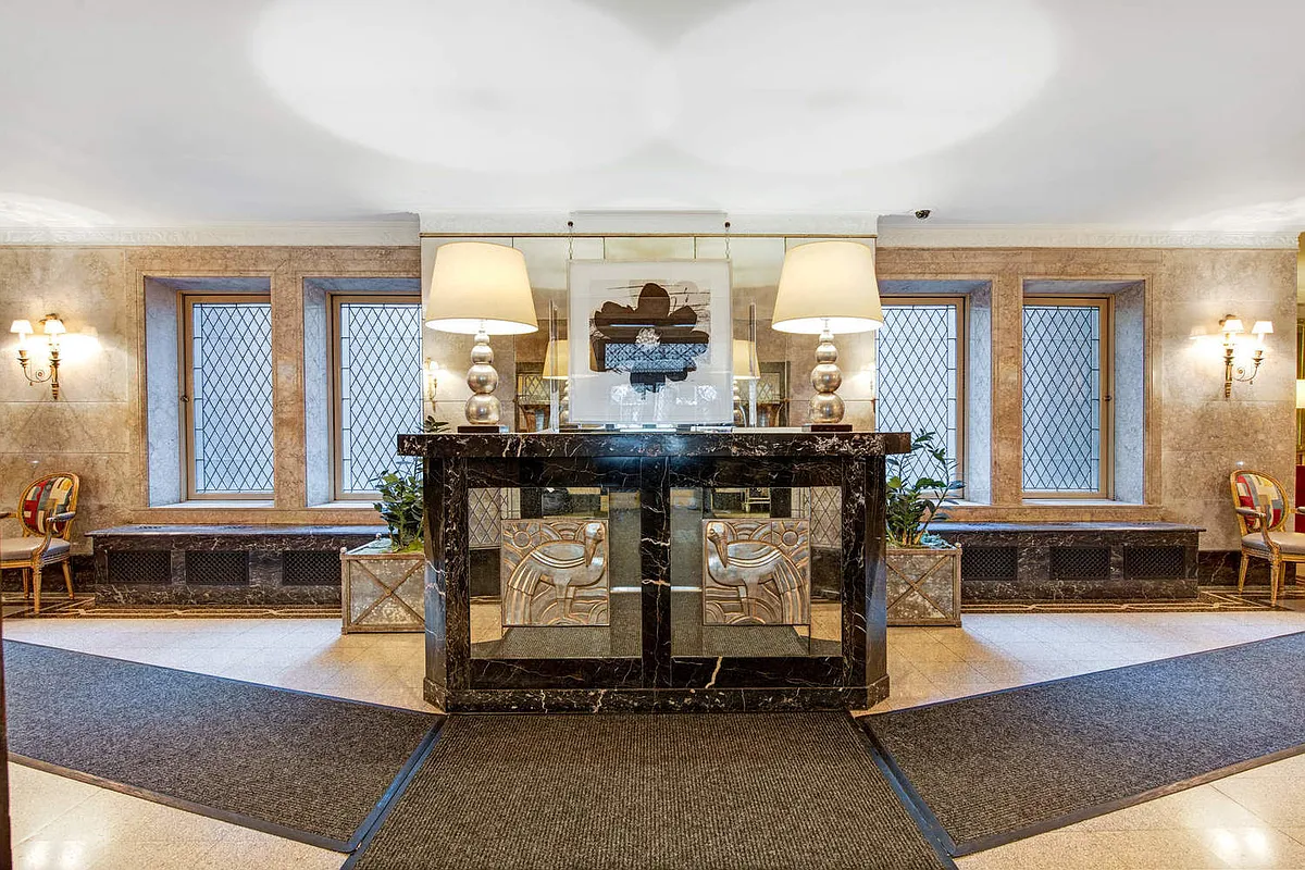 308 East 79th Street, Unit 4K Manhattan, NY 10075 - Photo 7 of 11 a living room with furniture and large windows