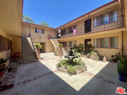 an aerial view of a house with a yard and potted plants